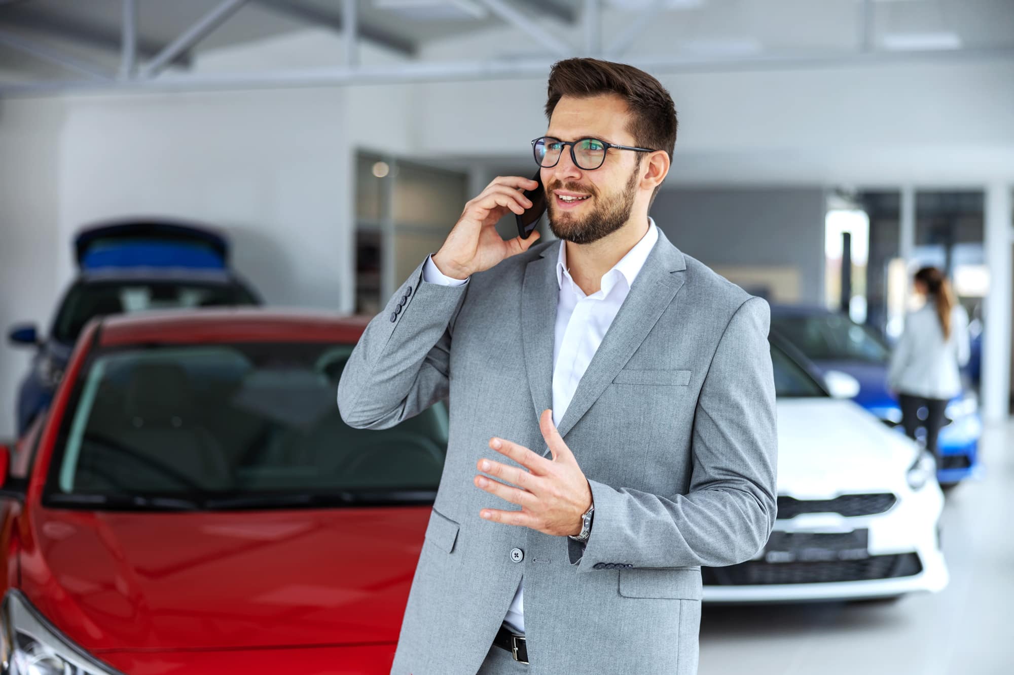 Person talking on phone in dealership
