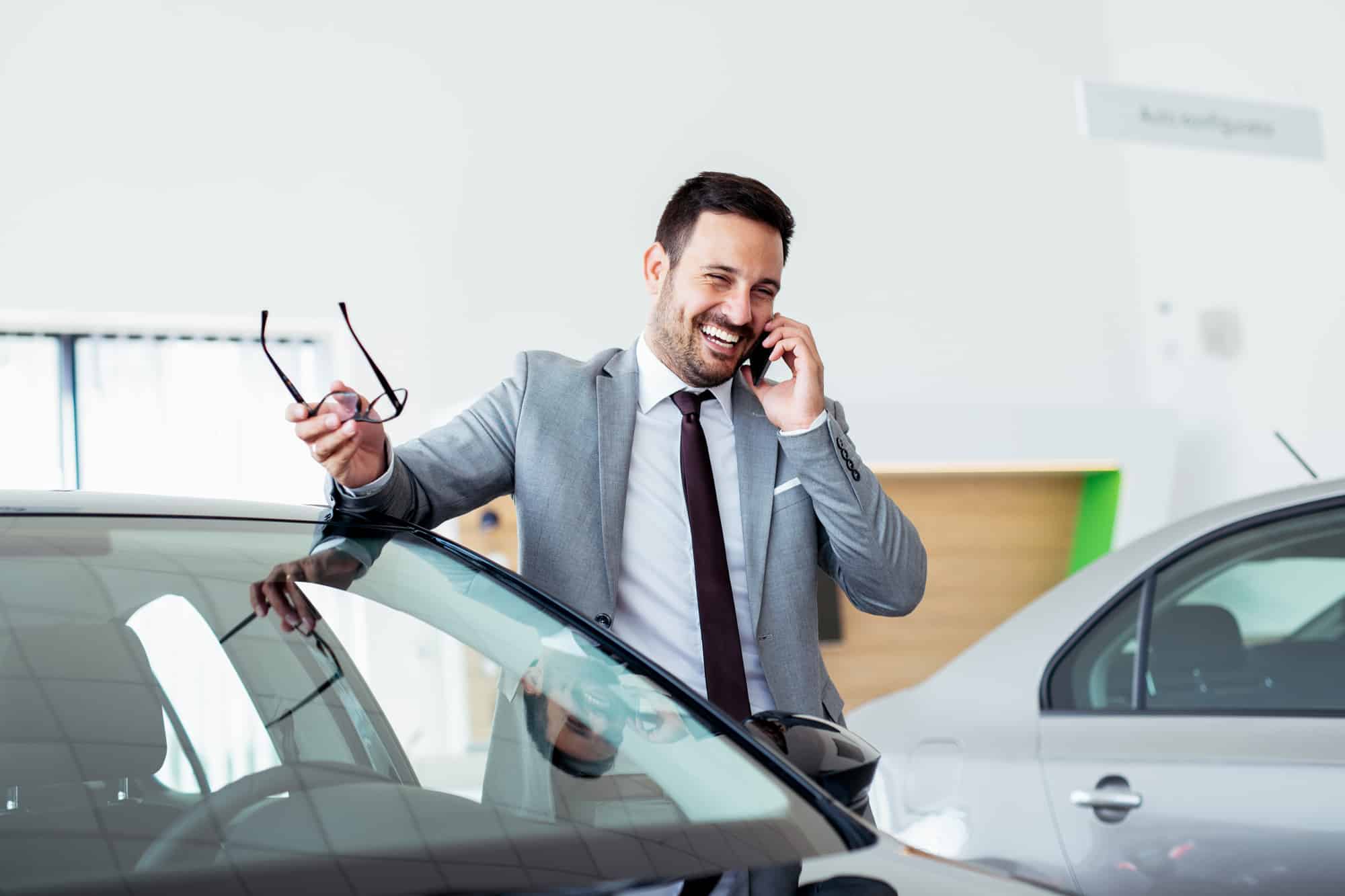 Person at dealership on phone laughing