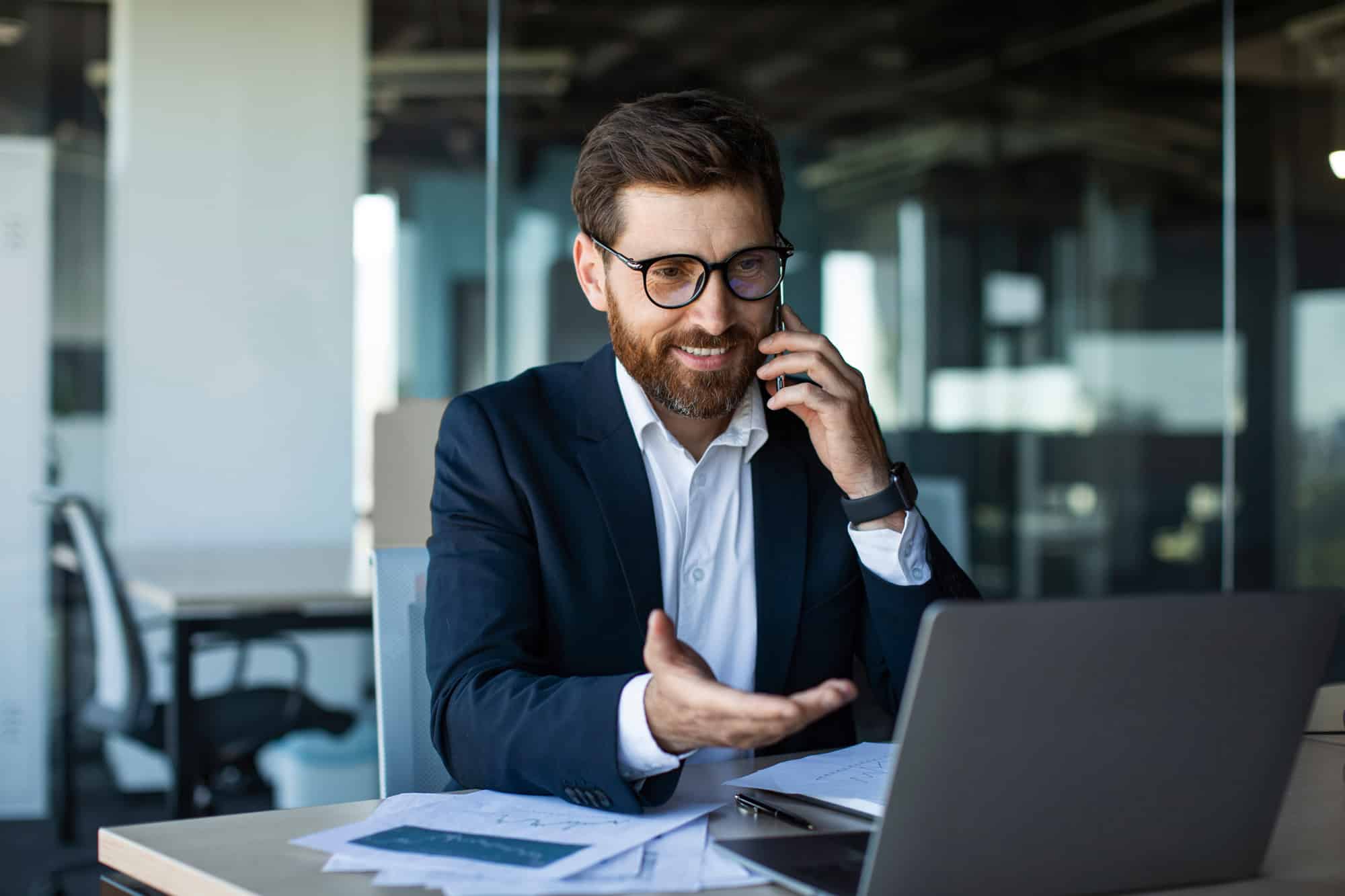 Person on the phone in front of laptop